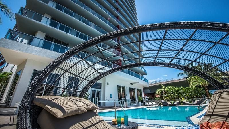 Pool deck with egg chairs and city view
